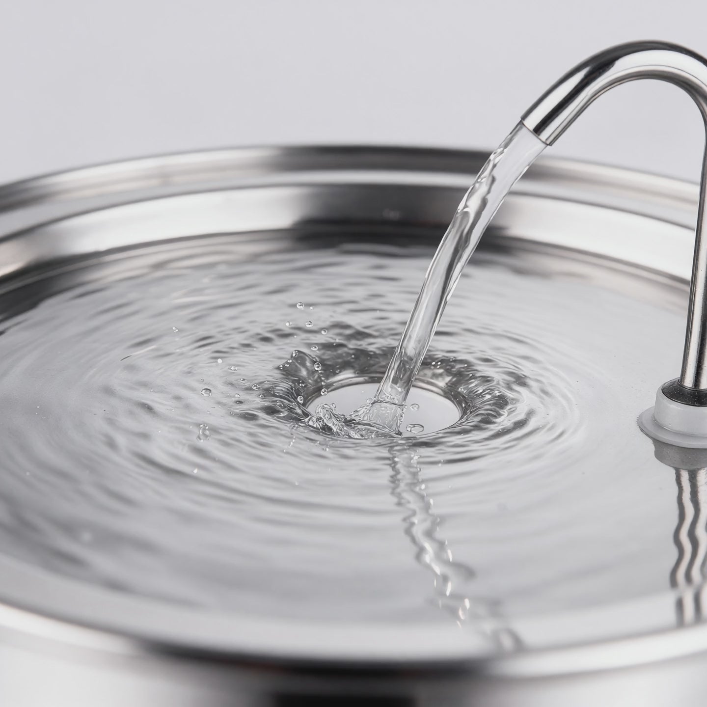 Wasser läuft aus dem Bogenauslauf der Tatzenquelle in die offene Trinkfläche